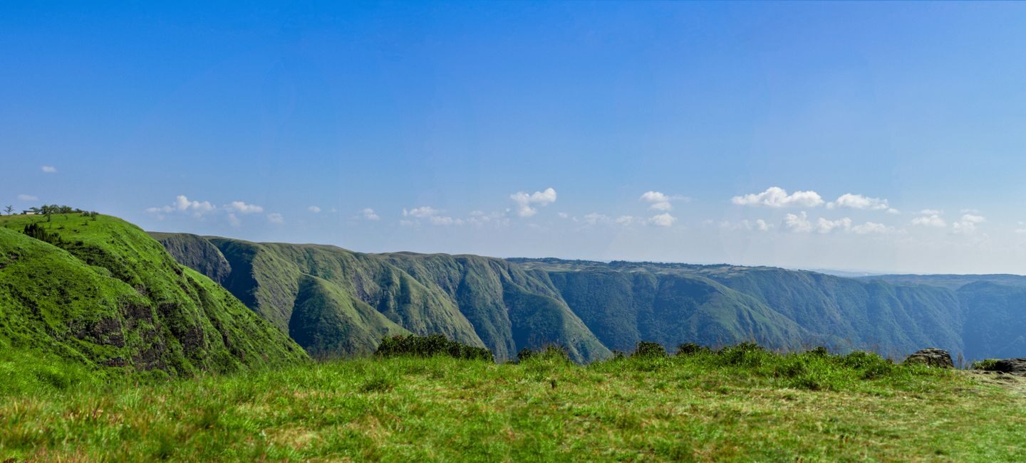 Seven Sisters of India landscape of green hill ranges in Meghalaya under a blue sky