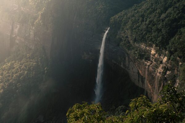 Cherrapunji's Nohkalikai Falls plunging from a green cliff into a pool in Meghalaya