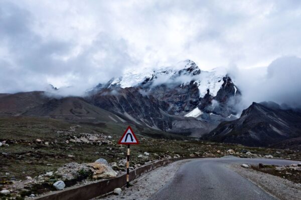 Sikkim permit zone road curving towards snow mountains in North Sikkim
